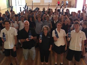 Peter Hannan and Kerryn Wood from the Sapphire Coast Marine Discovery Centre, present water bottles to students of Lumen Christi Catholic Collage at Pambula.