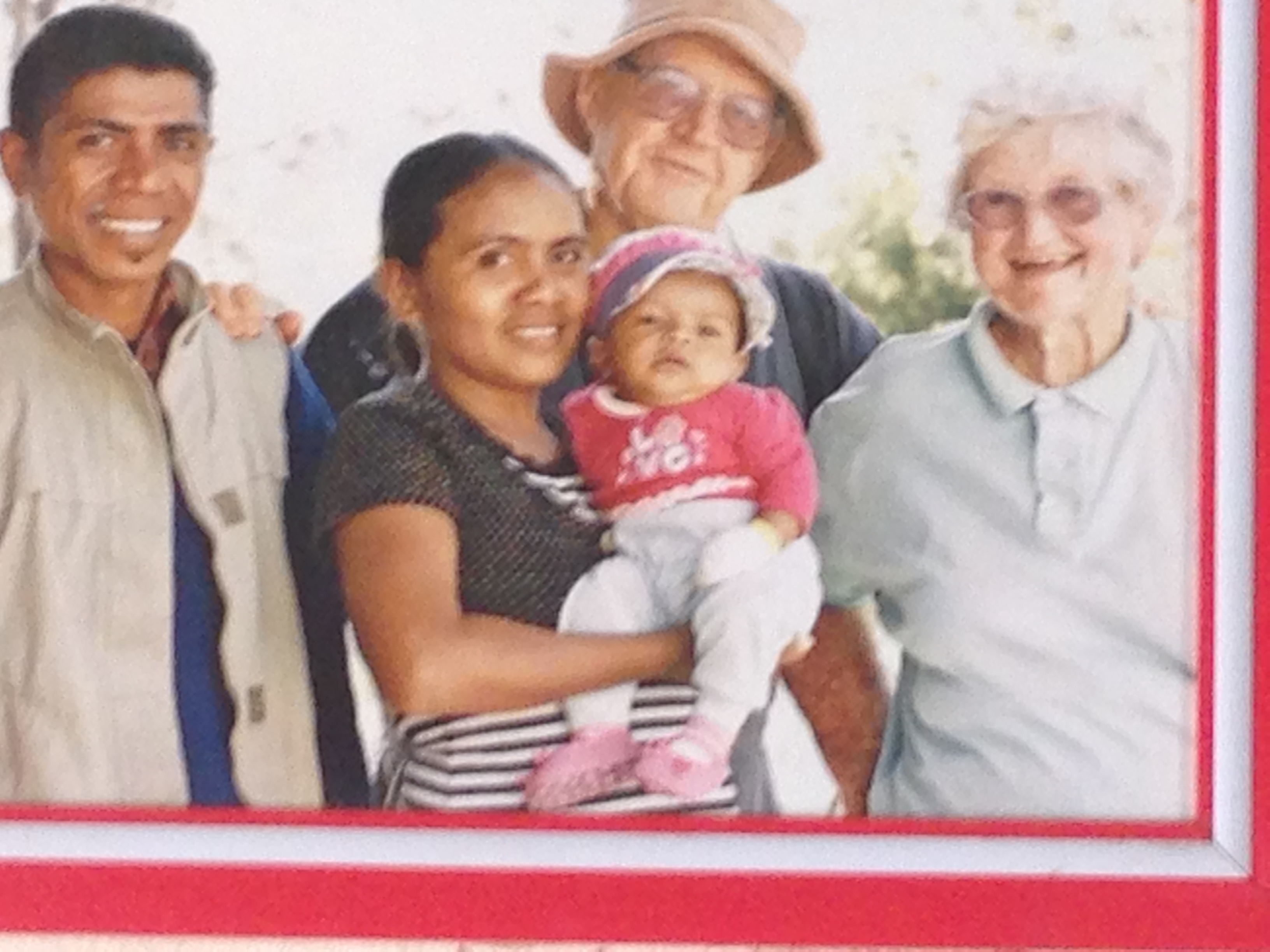 Jose Da Costa, his partner Lucy and their eldest daughter Moira, named after Moira Collins, pictured here with husband Jim. Both founding members of the Bega Valley Advocates for Timor Leste. This photo hangs on Jose and Lucy's wall.