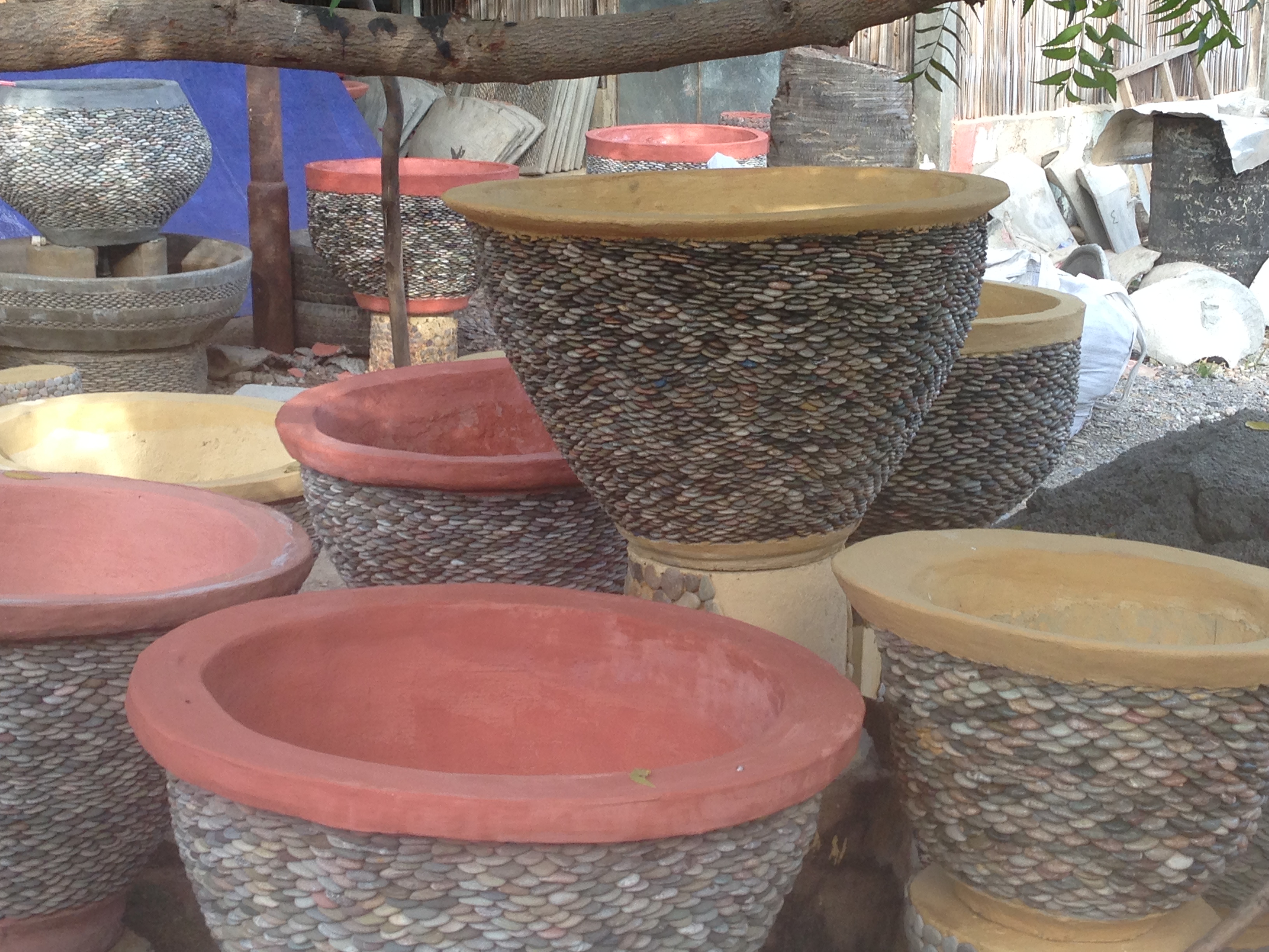 These cement and pebble pots support Jose and his extended family. Pebbles a plenty in Timor Leste.