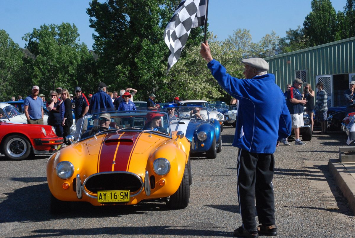 Keith Montague (deceased), one of the founding member of Cooma Car Club waves off a rally. 