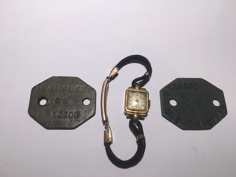 Dog tags belonging to Ian Florance and C Symes, and the watch given to the Symes family for keeping Ian alive.