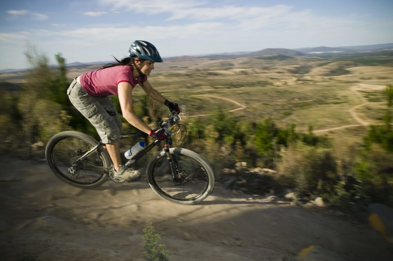 Woman riding mountain bike at Stromlo Forest Park