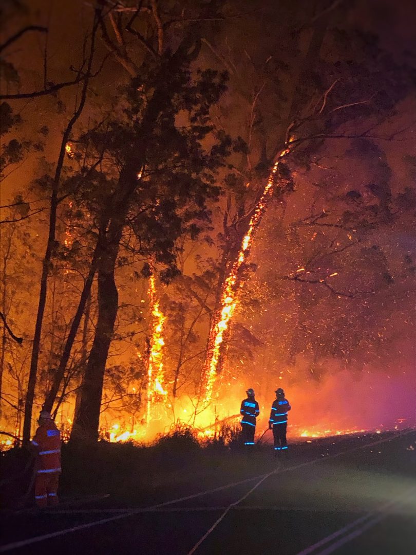 Firefighters battling the Currowan bushfire at night.