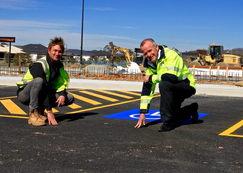 Gabe Vermeesch (left), the project engineer with the car park and netball court builders Huon, and Googong township project director Malcolm Leslie getting a feel for the recycled asphalt surface.