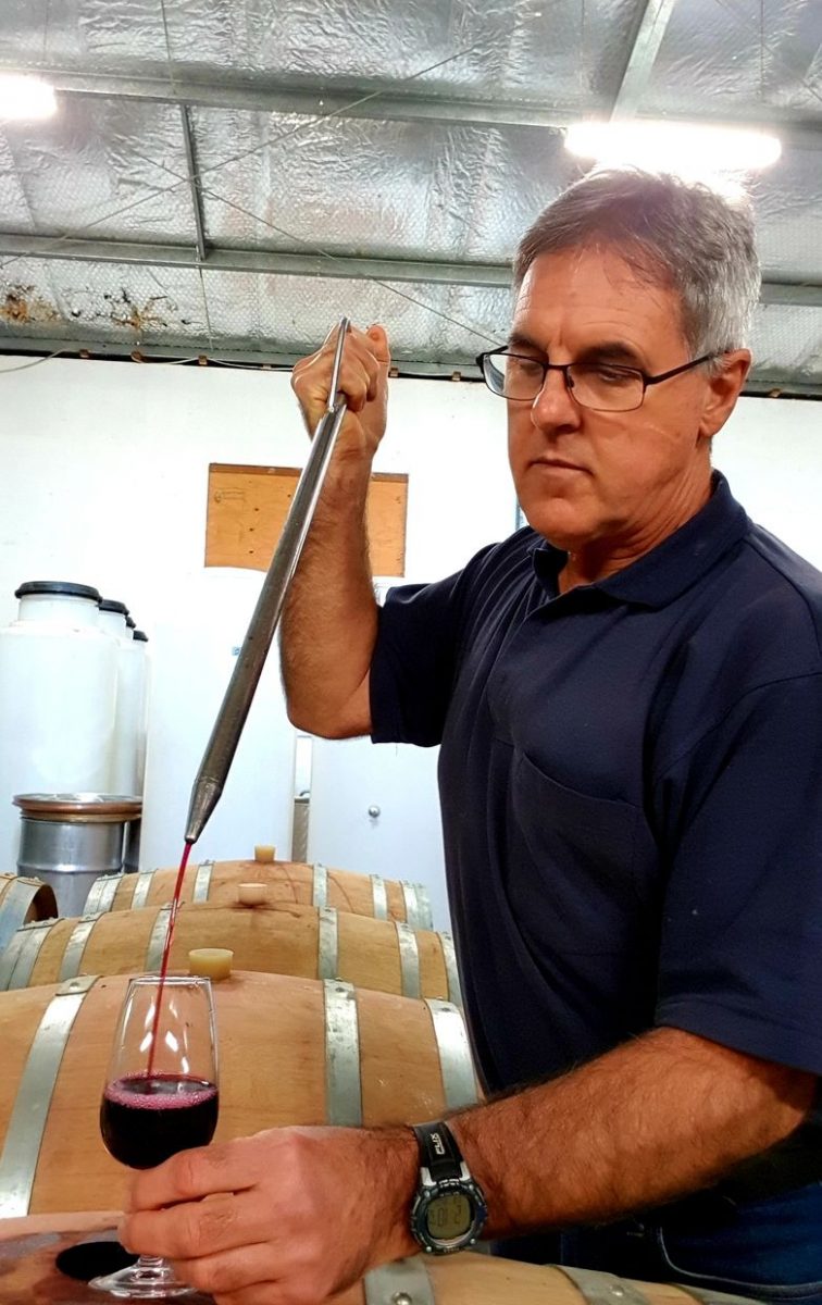 Ironcutter Wine's Brian Sinclair pouring red wine into glass.