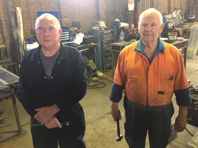Rob Wallace (left) and Brian Mills (right) standing in workshop.