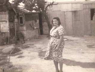 Historic photo of Dixie Byrne (nee Brown) standing outside her house at Oak Hill in Yass