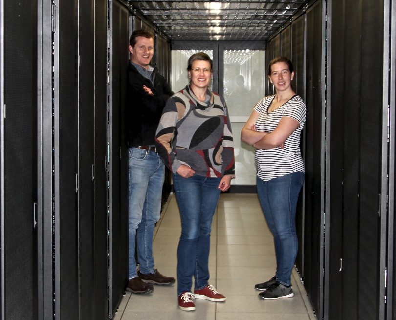 From left: Dr Stephen Fairweather, Associate Professor Megan O'Mara and Dr Katie Wilson with the Gadi supercomputer at ANU.