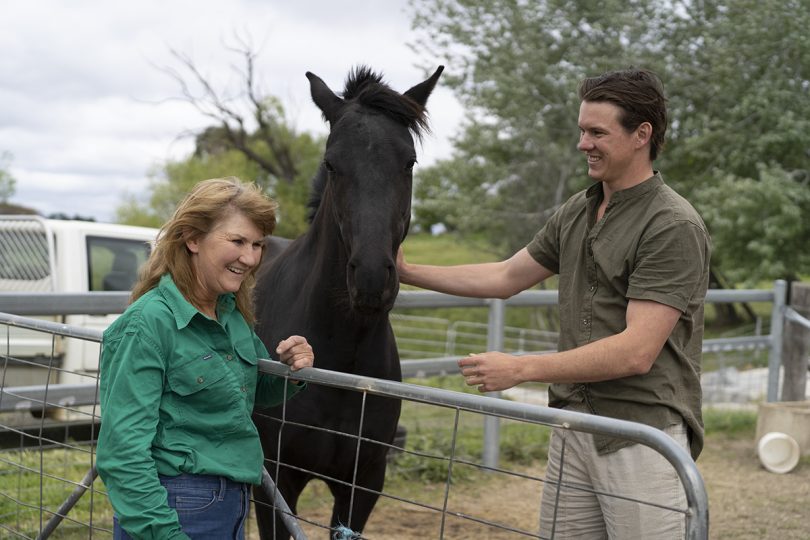 Anne McGrath and her son Fred with a horse at their property at the Majura Valley.