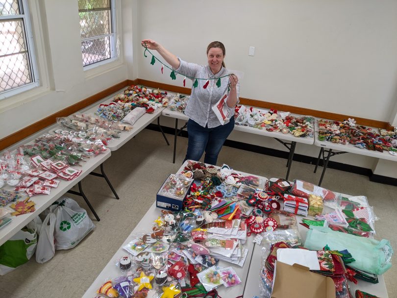 Bianca Brownlow in room full of donated handmade decorations.