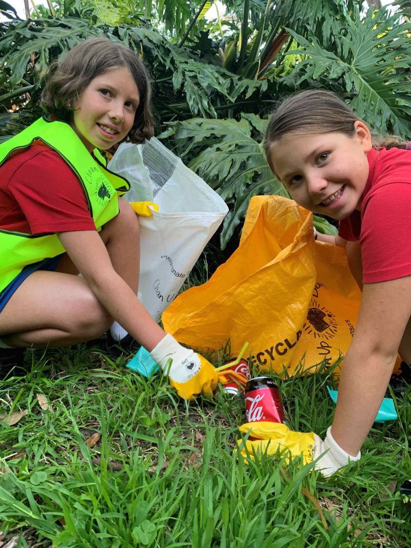 Image of two girls with rubbish bags during Clean Up Australia Day.