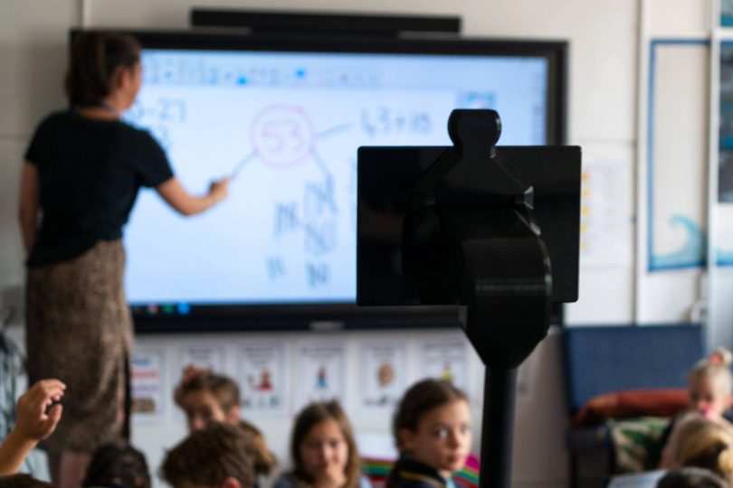 Robot in classroom with students and teacher