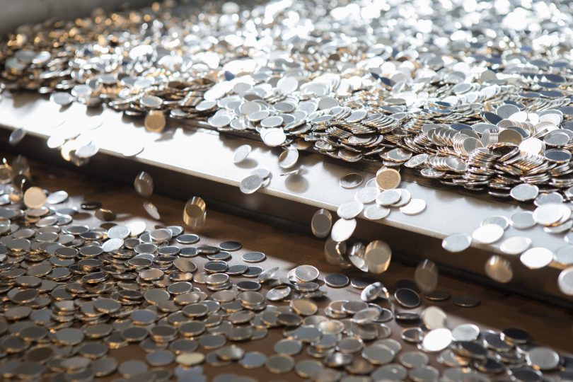 Blank coins fall from conveyor belt at Royal Australian Mint