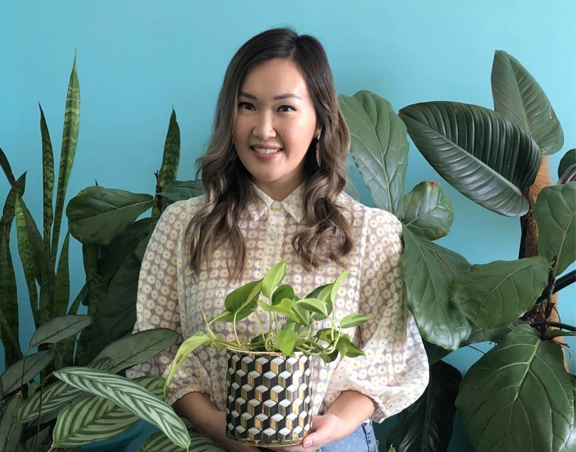 Tammy Huynh surrounded by indoor plants