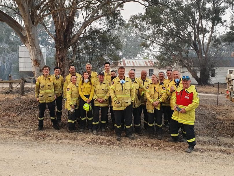 Group of firefighters in yellow coats