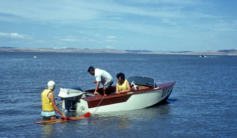 Three people on speedboat on Lake George in 1964