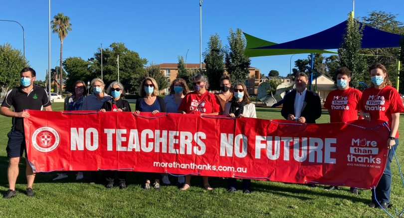 Teachers holding a banner