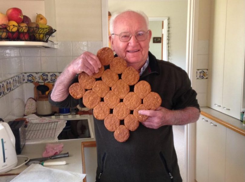 Man holding up biscuits