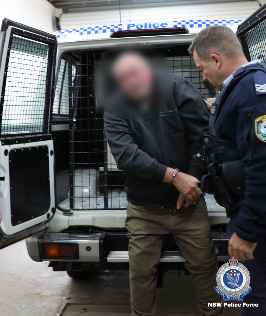 man being led out of police van