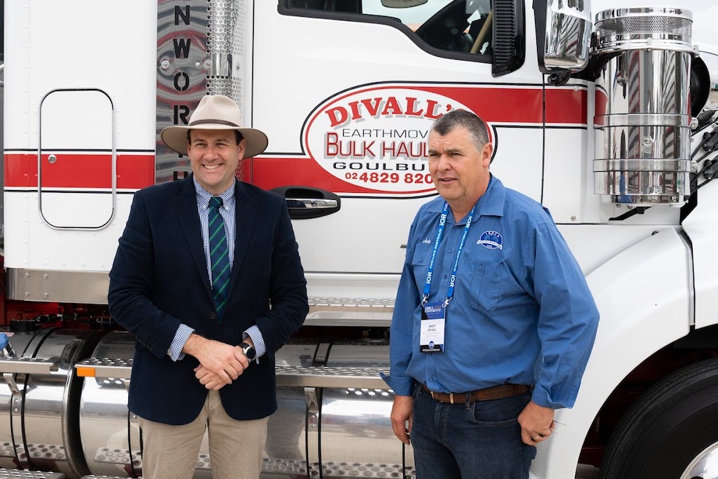 Minister for Regional Transport and Roads Sam Farraway and owner of Divall's Earthmoving and Bulk Haulage Andy Divall in front of a truck