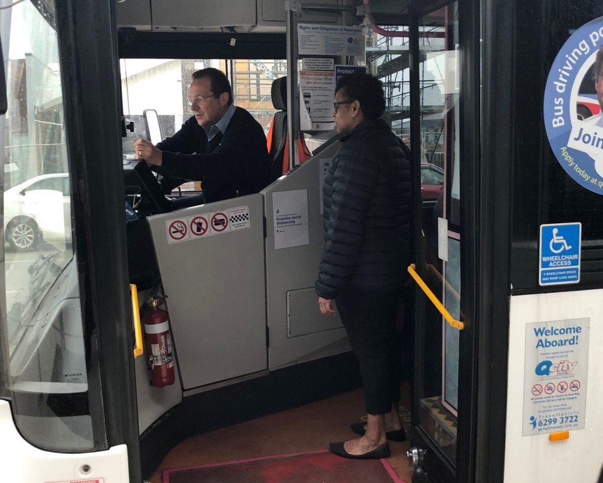 Person hopping on a Q City bus