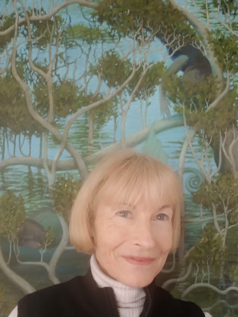 Frances Luke in front of a painting of mangroves