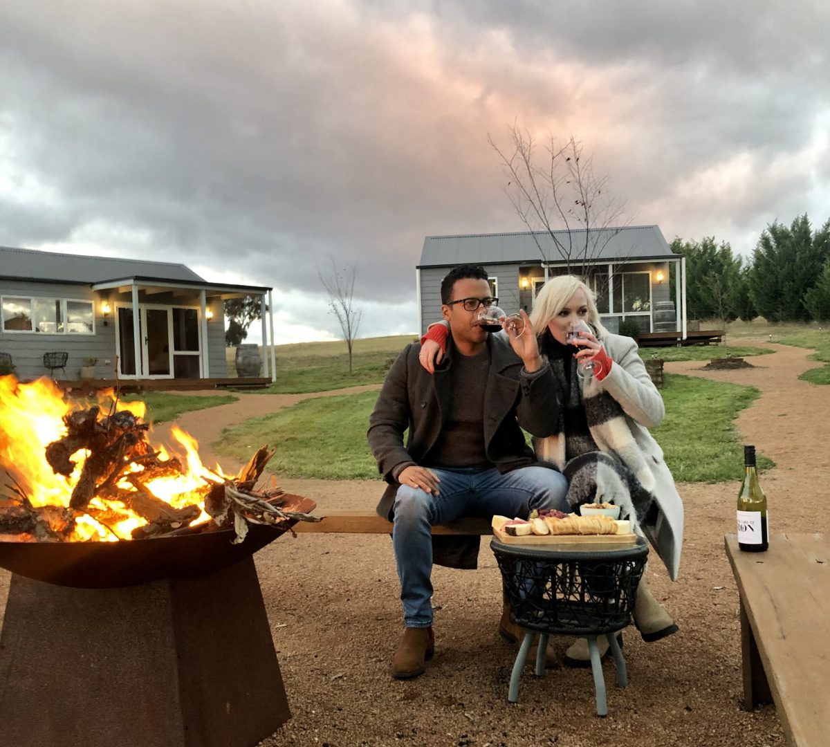 A couple drinking wine at their Tarragandra Hill accommodation
