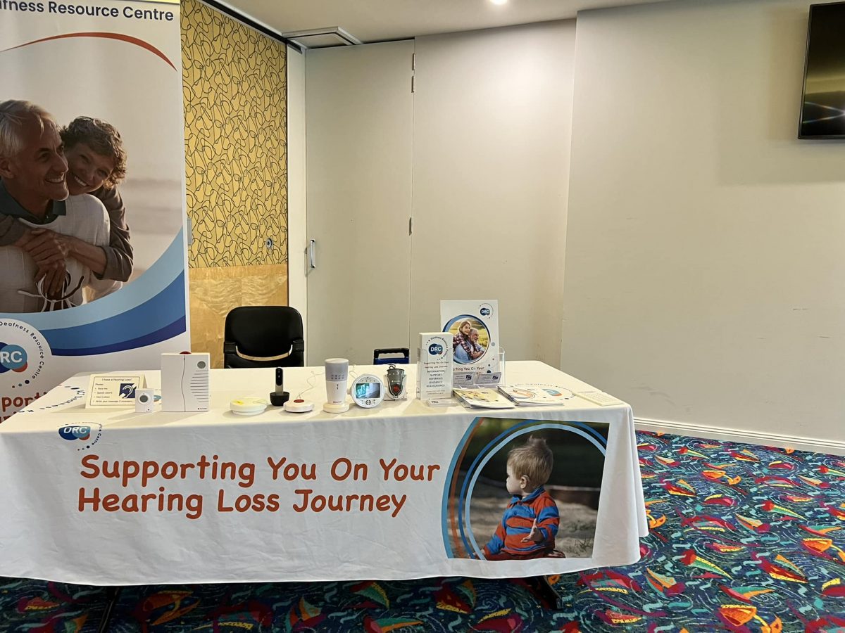 an information desk with ACT Deafness Resource Centre branding