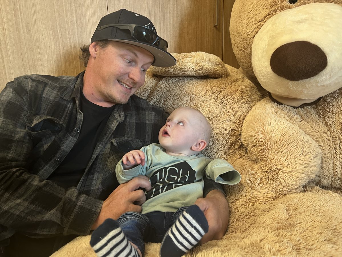 Dad and son on giant teddy bear