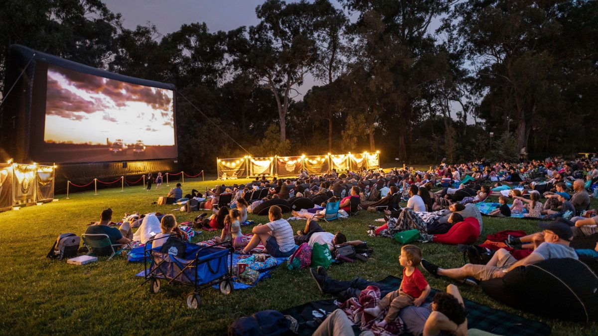 People watch an outdoor movie at Sunset Cinema in Canberra