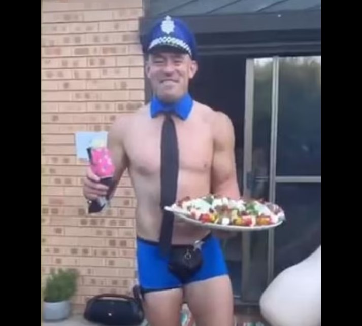 Terry Campese dressed as a police officer at a party