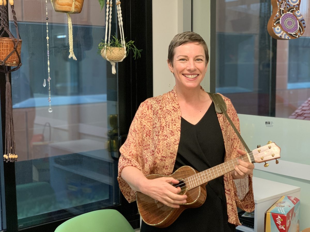 Lady in peadiatric ward playing a ukulele