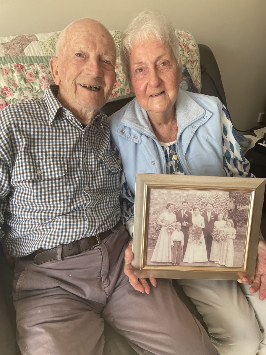 Couple holding wedding photo