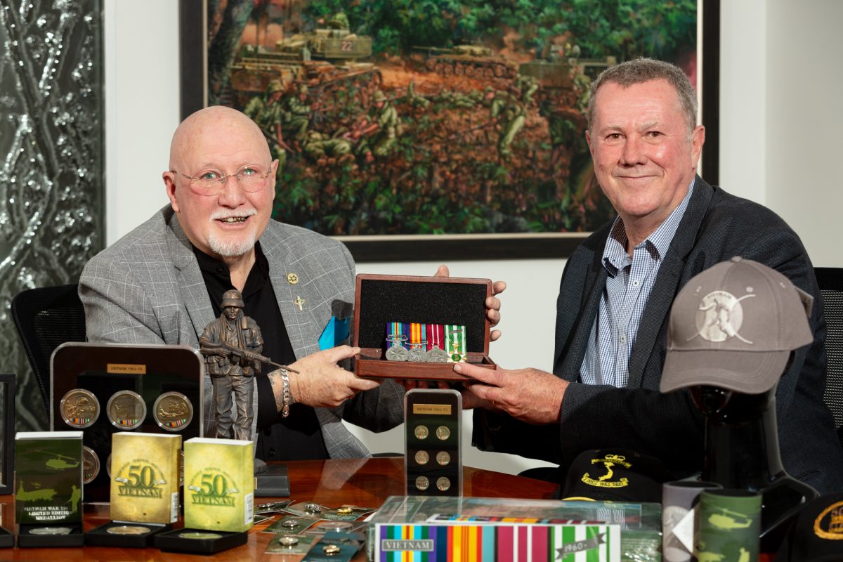Wayne Lyons and Steve Rainey holding medals