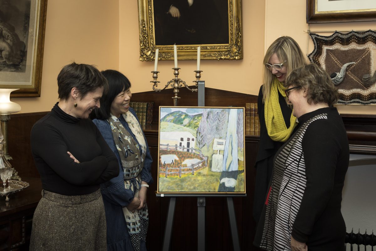Four women looking at painting