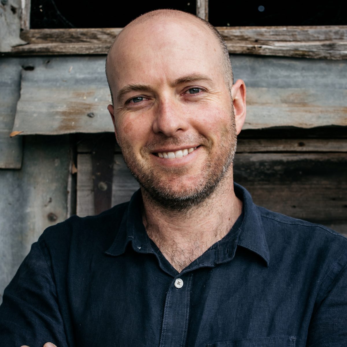 Smiling man with crossed arms