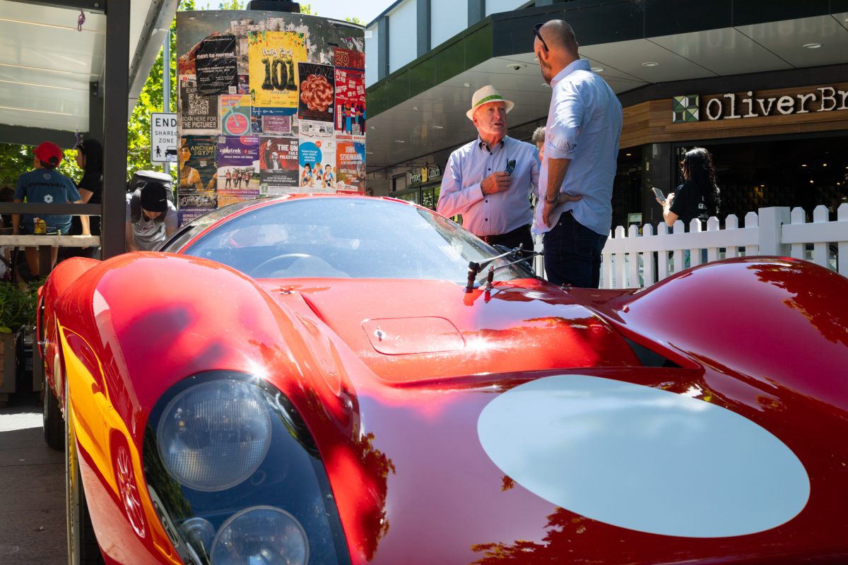 Two men looking at sports car