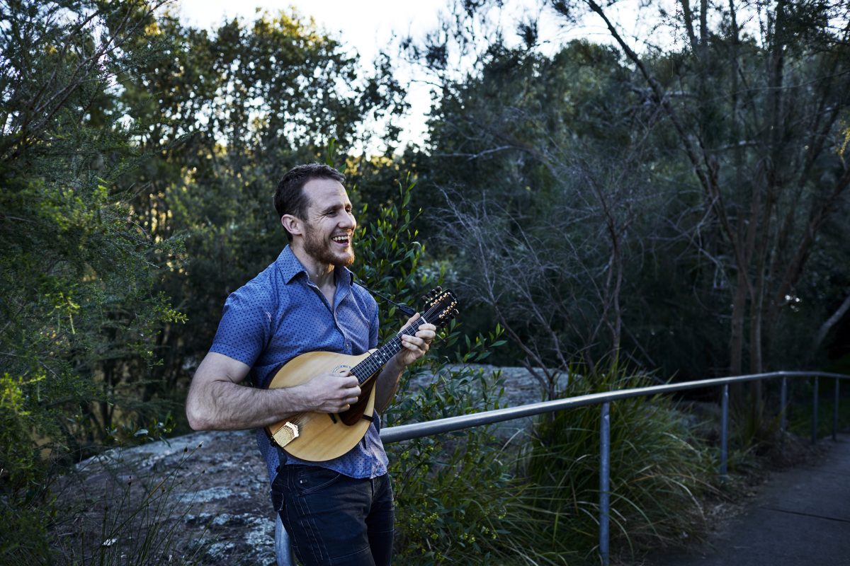 Michael Sollis strumming a ukulele