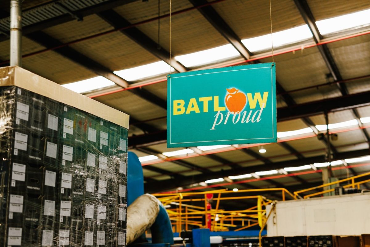 A green sign reading 'Batlow proud' where the o in Batlow has been replaced with a red apple.