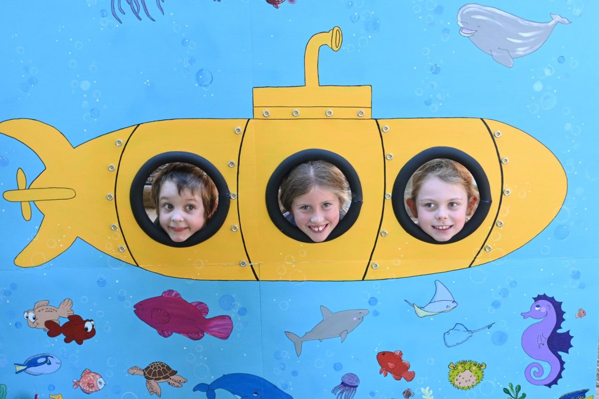 Three kids in a submarine background