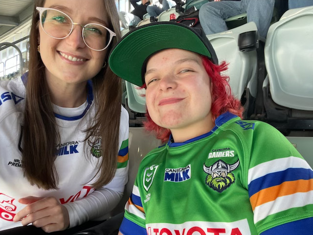 Two girls in NRL jerseys