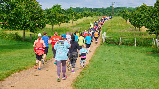 A group of people running up a track