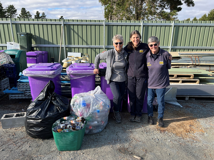 Zoo volunteers standing next to recyling they have picked up.