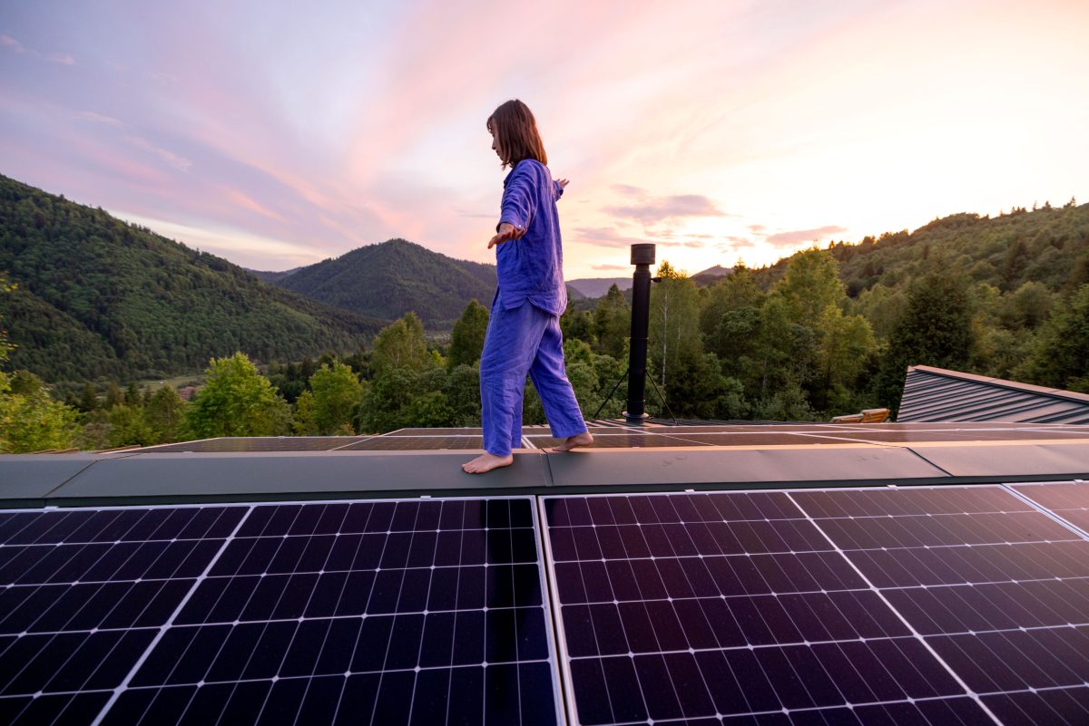 woman walking on rooftop with off grid solar