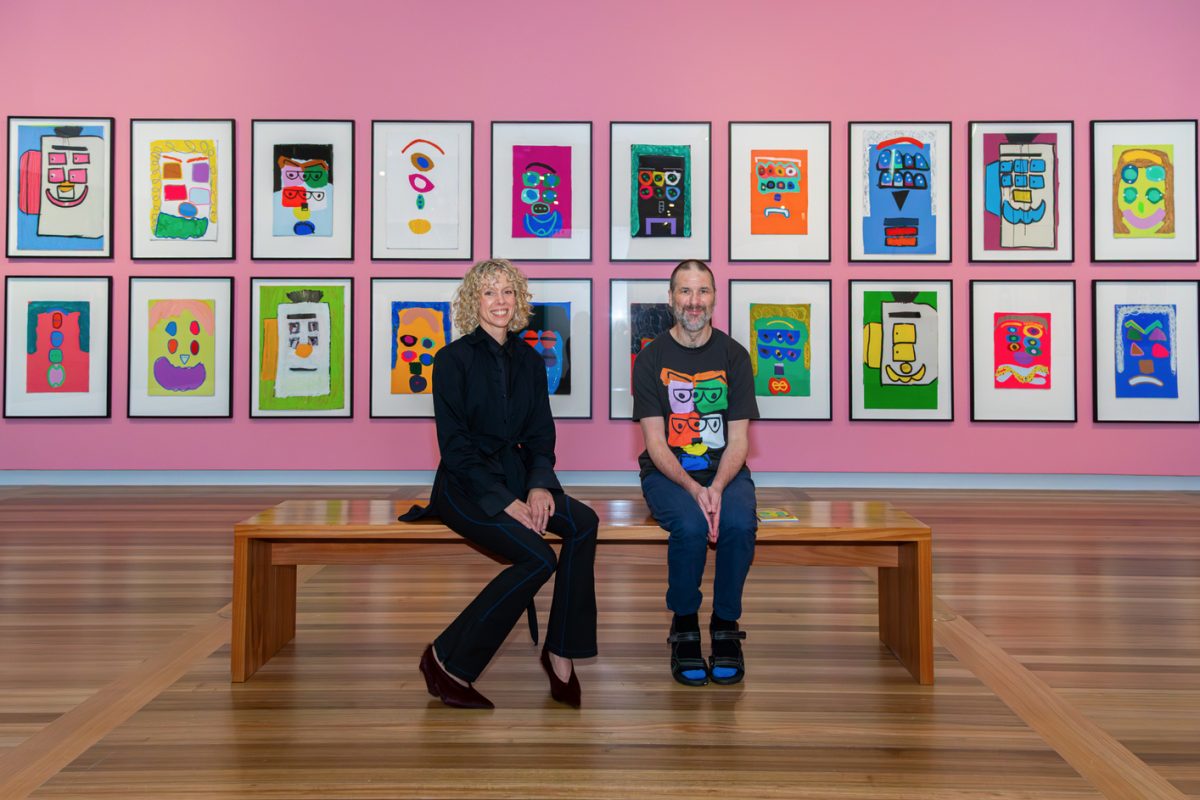 Two people seated in a gallery