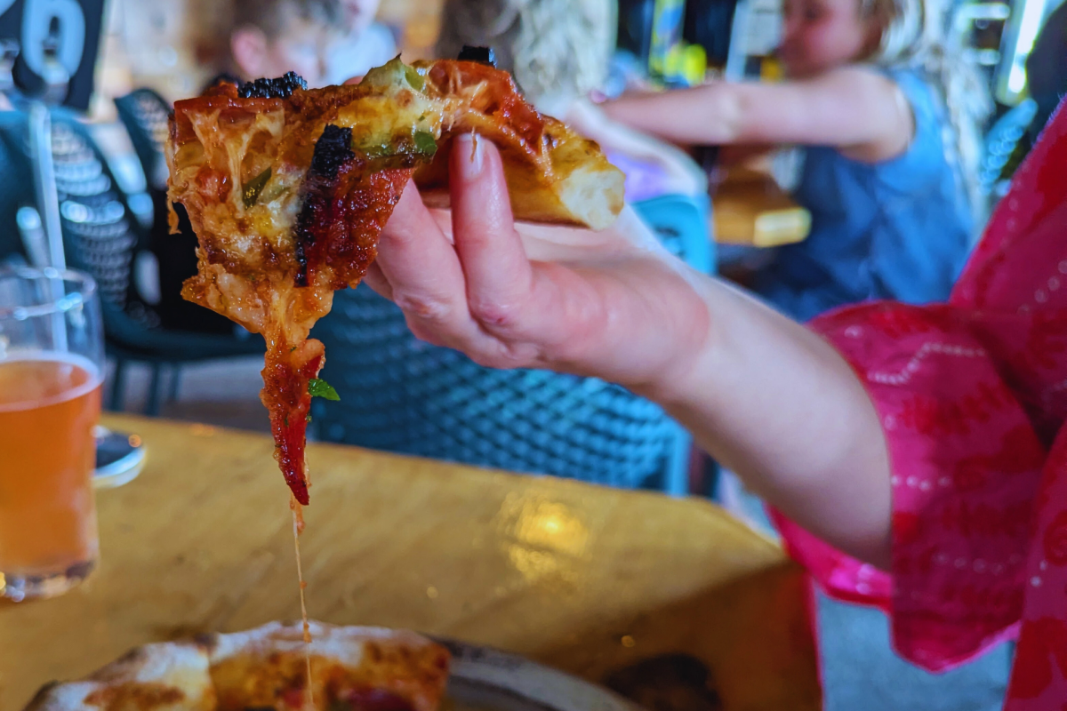 Pizza in hand.