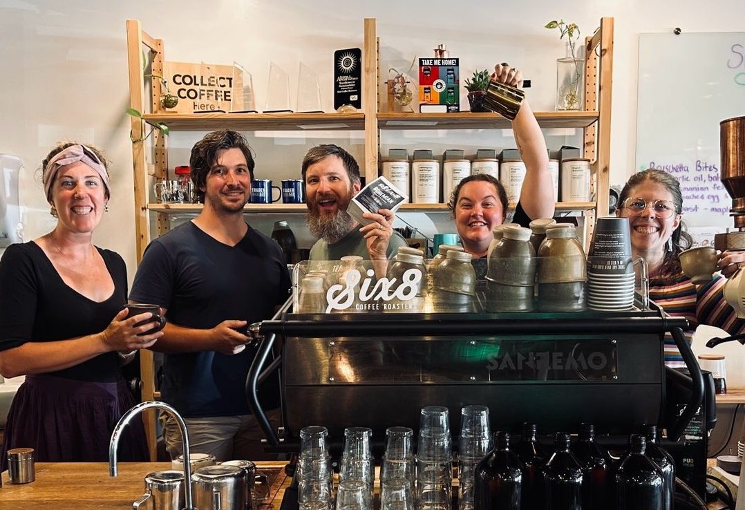 Trader & Co. staff posing behind counter
