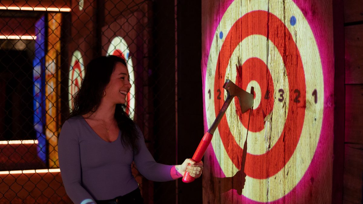 woman at an axe bullseye target.