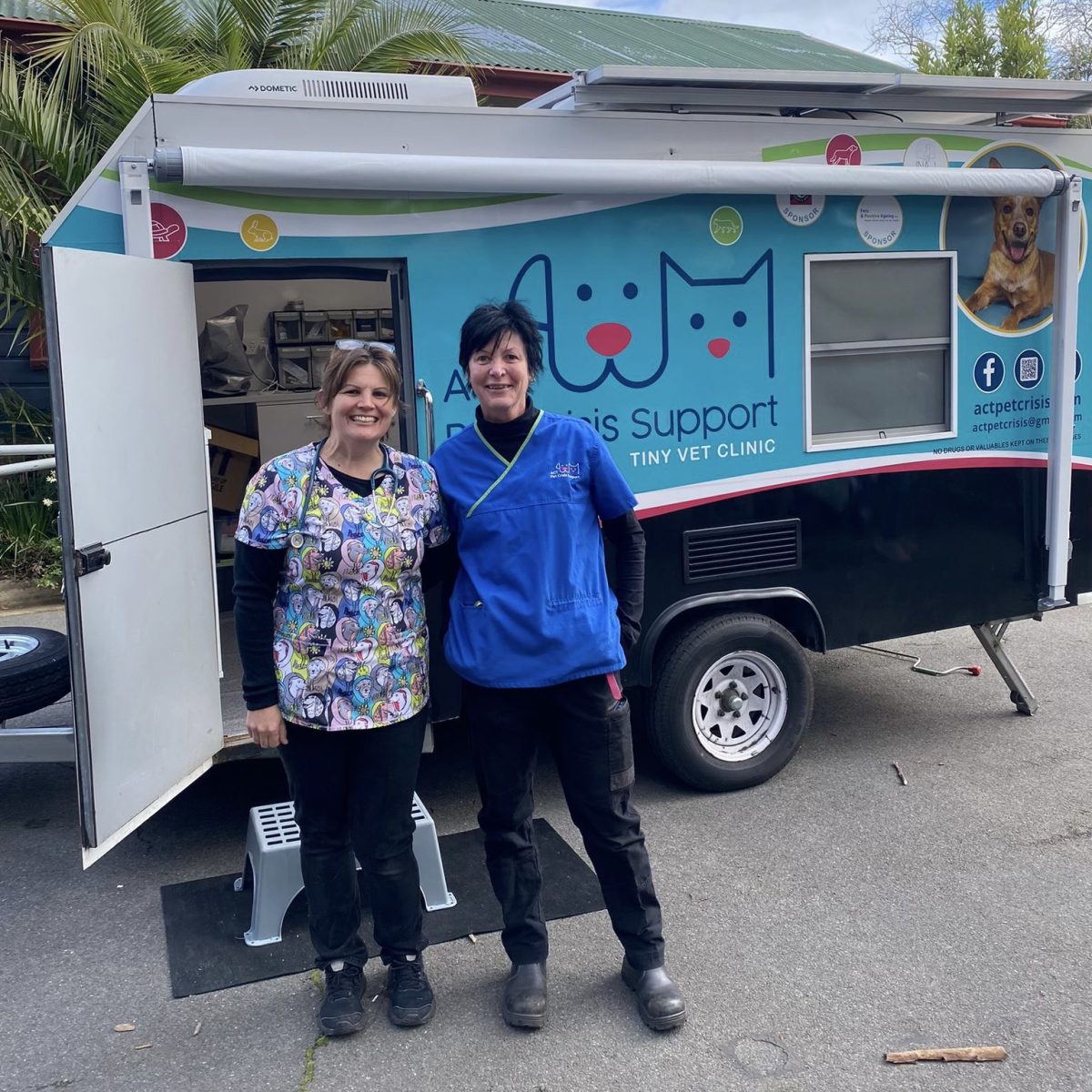 two women in front of the Tiny Vet Clinic van