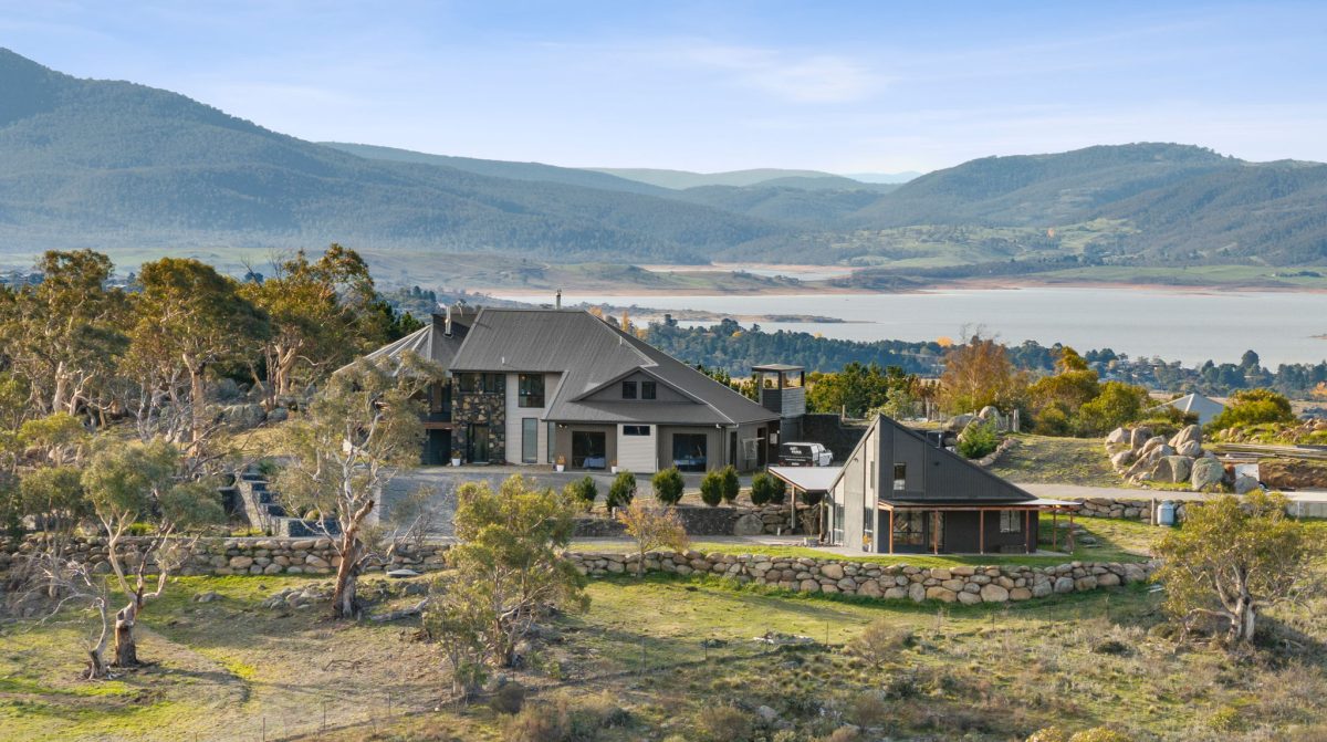 hero shot of home and surrounds with lake in background